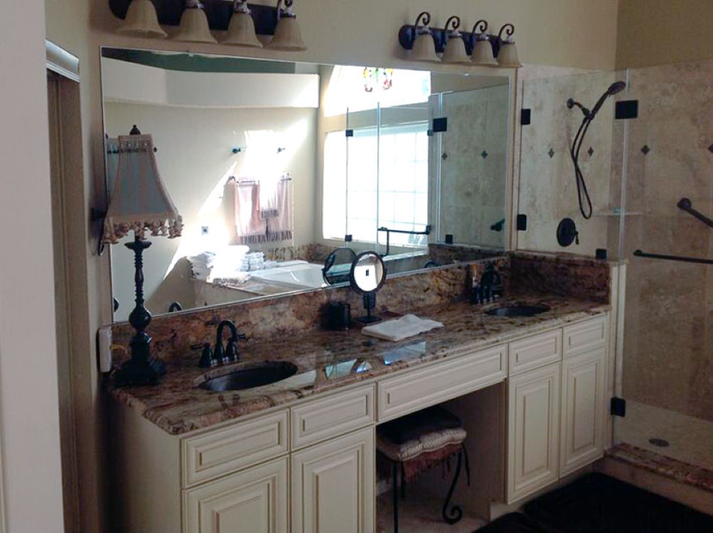 Custom glass bathroom mirror spanning a full vanity wall