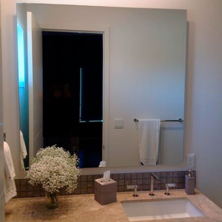 Custom bathroom mirror floated off the wall on standoff hardware