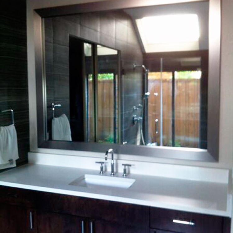 Framed custom bathroom mirror above a double vanity