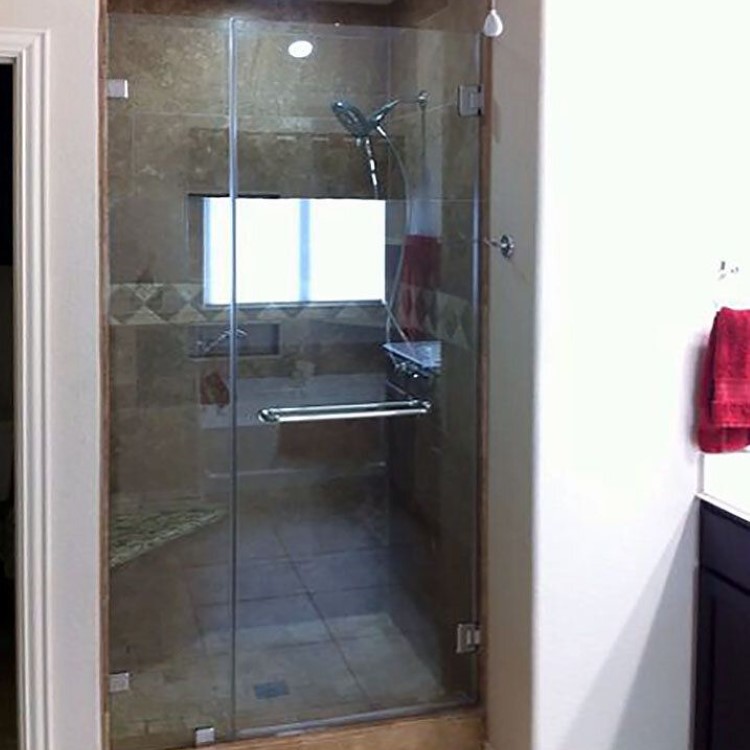 Frameless inline glass shower enclosure in a guest bathroom