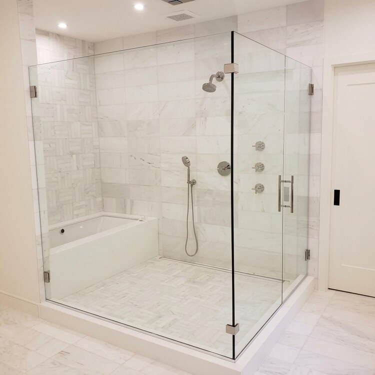 Frameless 90 Degree Glass Enclosure in White Marble Frameless 90 degree glass shower enclosure in a white marble bathroom