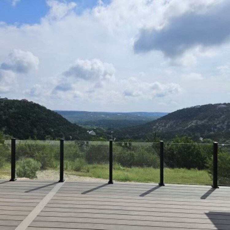 Glass Deck Railing with a Hill Country View Frameless glass deck railing keeping an open hill country view