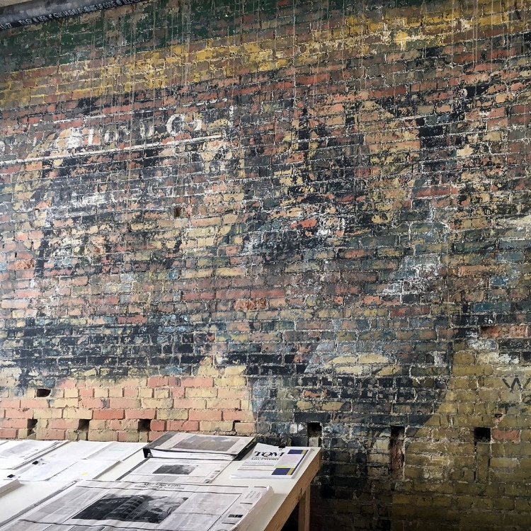 Historic painted brick wall uncovered during a building renovation
