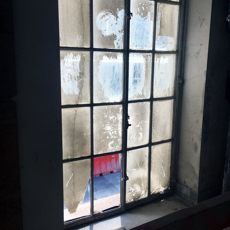 Original steel factory window retained in a historic building renovation