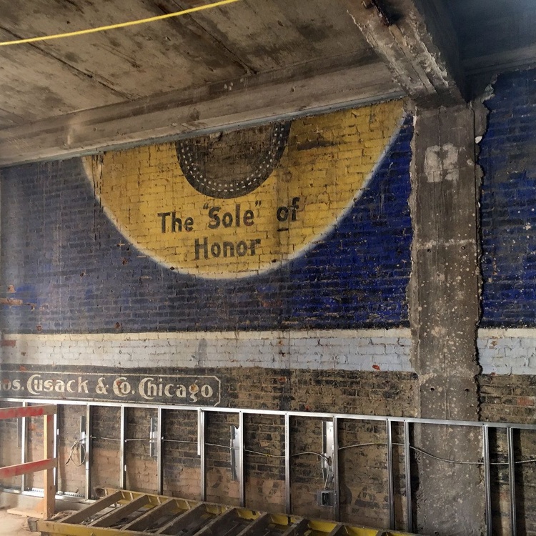 Original painted signage preserved on an interior wall during renovation