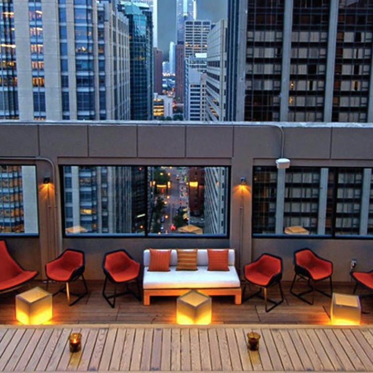 Rendering of a rooftop lounge at dusk on a renovated historic building
