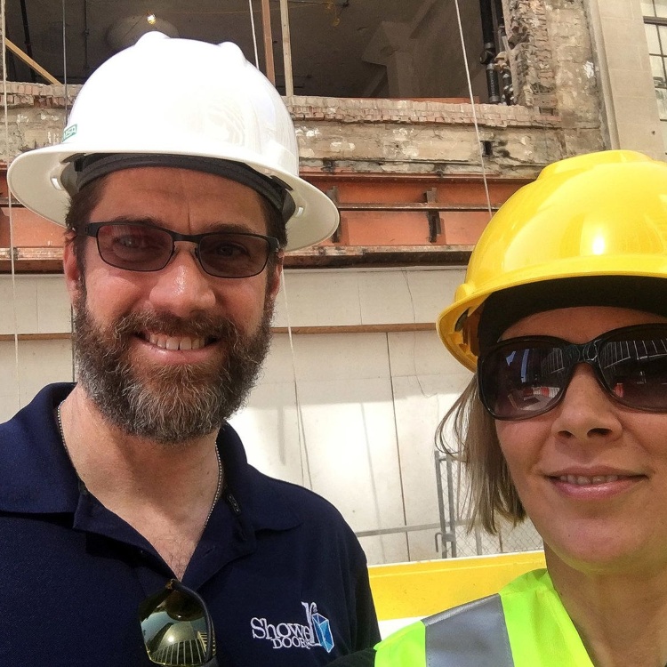 Shower Doors team members in hard hats on site at a historic renovation project