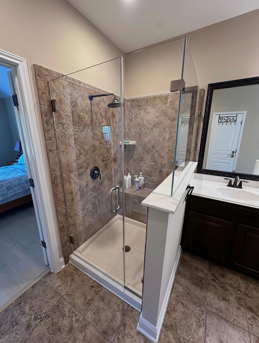 90-degree frameless shower enclosure in low-iron glass on a tiled pony wall in Austin, TX
