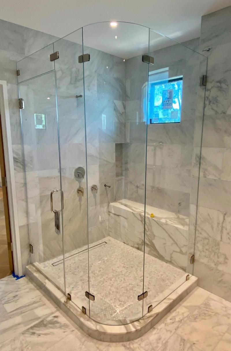 Custom corner shower enclosure with curved glass in Austin, TX