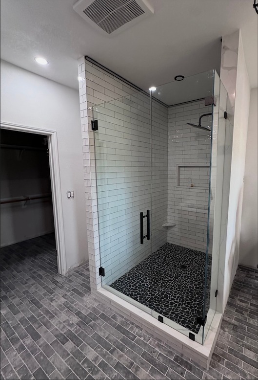 The same Manchaca, TX shower after the full 90-degree frameless enclosure was installed