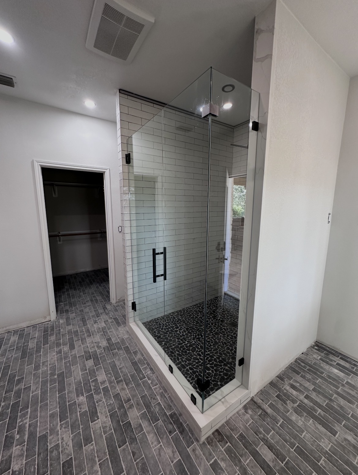 Full 90-degree frameless shower enclosure with matte black hinges and clamps in Manchaca, TX