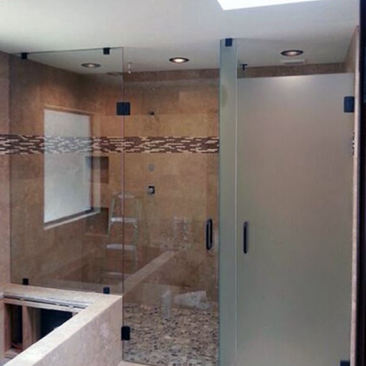 Custom etched glass inline shower door with a frosted panel