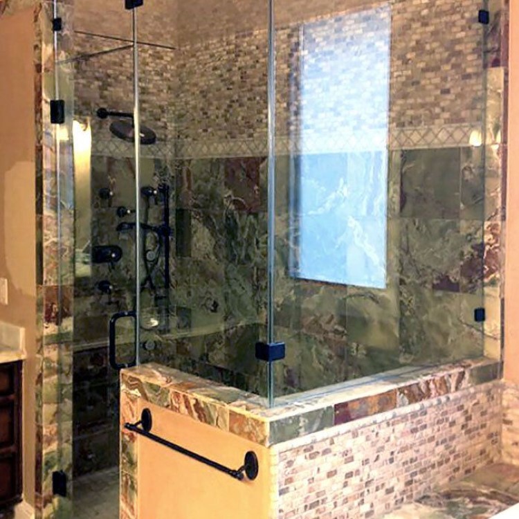 Frameless 90-degree steam shower enclosure with a full-height glass panel