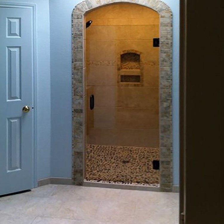 Single frameless glass shower door with a brushed pull handle