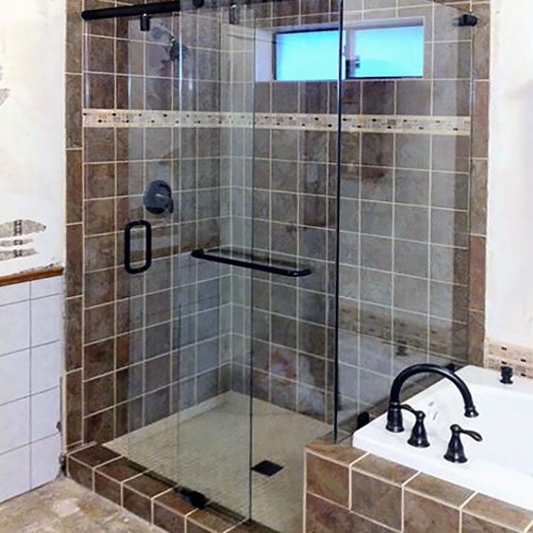 Sliding glass shower door and tub enclosure combination