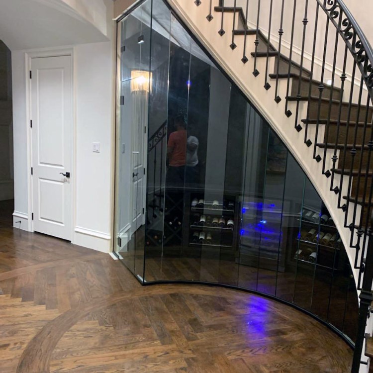 Glass enclosure over a spiral wine cellar entry